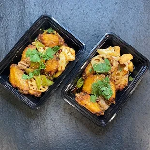 two takeout containers of food