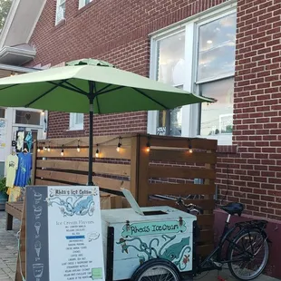 an ice cream cart with an umbrella