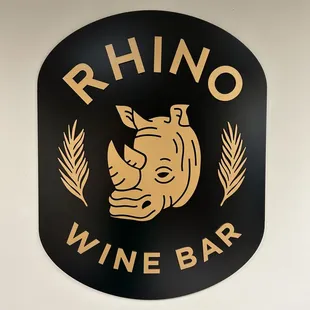 rhino logo on black sign