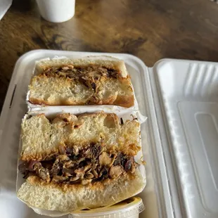 two sandwiches in a styrofoam container