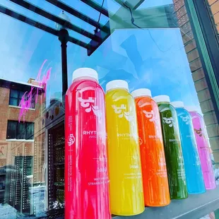 a row of colorful juice bottles