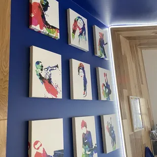 a blue wall with art on it