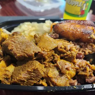 Curry Goat with cabbage rice and plantains