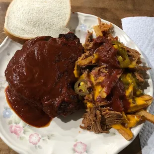 a plate of pulled pork and french fries
