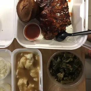 Baby back ribs with a side of collard greens and mashed potatoes oh and corn bread muffin