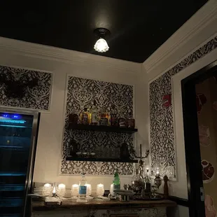 a bar area with candles and a wine cooler