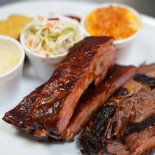 Juice brisket and pork ribs paired with mac n cheese, coleslaw and potato salad