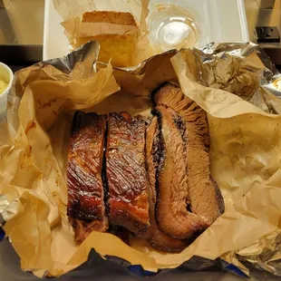 4 ribs, several slices of brisket, mac-n-cheese, beans, potato salad, corn bread and multiple types of sauce!