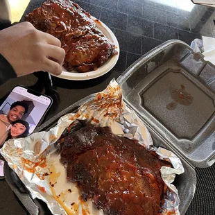 a person taking a picture of the ribs