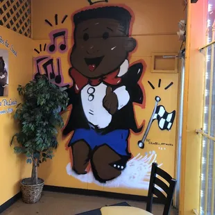 a mural of a black boy with a microphone