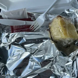a sandwich wrapped in aluminum foil