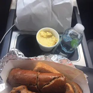 My lunch today-Potato Salad, Sausage Link sandwich and water. The white bag is for Dinner (Ribs)