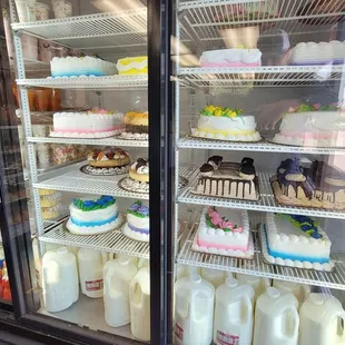 a display of cakes and milk