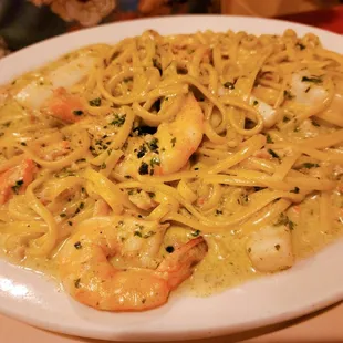 Seafood with pesto cream sauce