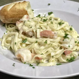 a plate of pasta with shrimp