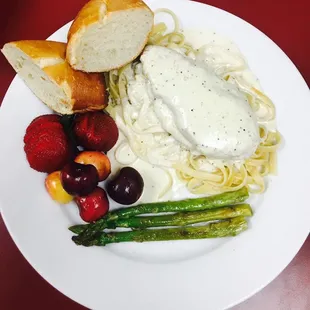a plate of pasta, asparagus and bread