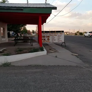 Patio and advertisement showing the different kinds of foods available.