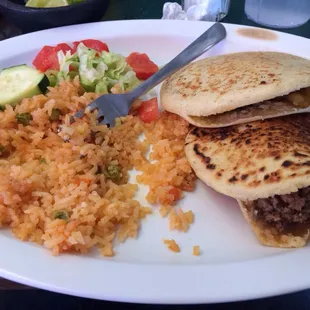 Maiz (corn) gorditas with a side of rice. Ground beef with potatoes and chicarron
