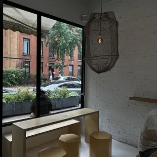 a man sitting at a table in front of a window