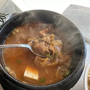 a bowl of soup with a spoon in it