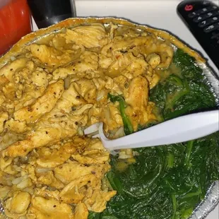 Boneless chicken curry over rice with spinach