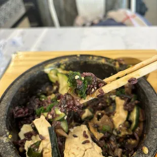 Stream coming off the food, crispy rice from hot stone!