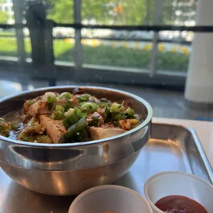 a bowl of stir fry with sauces