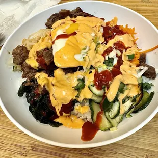 Kalbi Bibimbap bowl with spicy mayo and gochujang.
