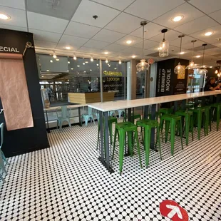 green stools and a black and white checkered floor