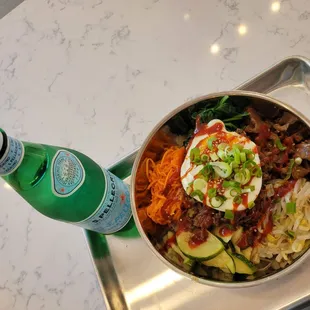 a bowl of food and a bottle of water
