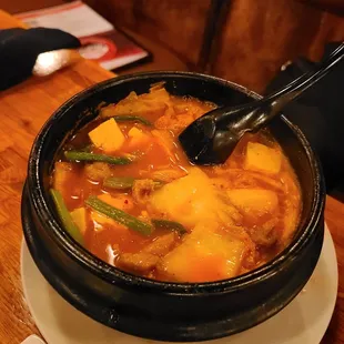 a bowl of stew with a spoon in it