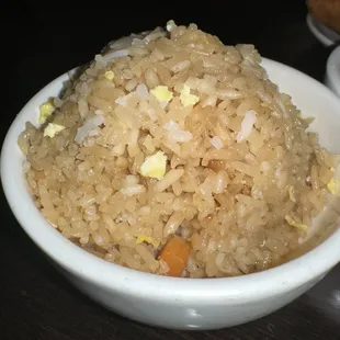 a bowl of rice with a side of dipping sauce