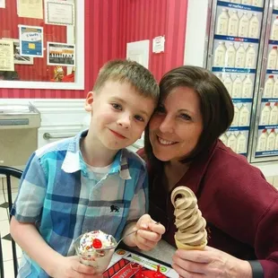 a woman and a boy eating ice cream