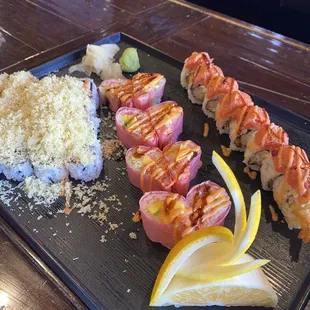 a plate of sushi and other food items