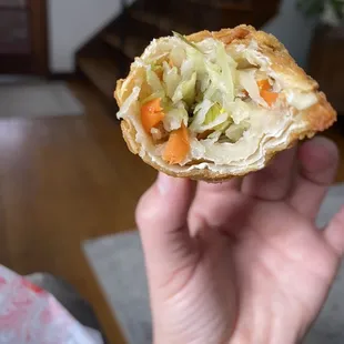 a hand holding a piece of food