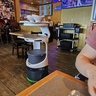 "Robot server" that rolls up to your table with your order on a tray.