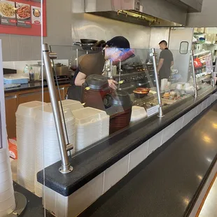 a woman preparing food in a restaurant