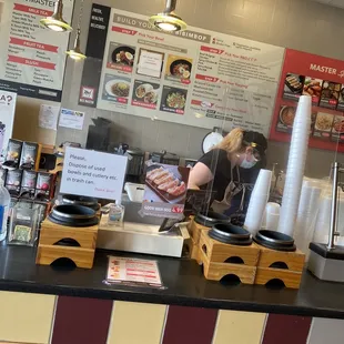 a woman preparing food in a restaurant