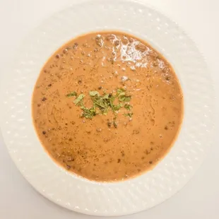 DAAL MAKHANI Lentils cooked with garlic, cumin, tomatoes, ginger, cream and butter sauce.