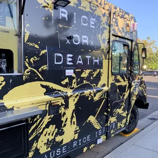 a black and yellow food truck