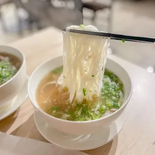 noodles being lifted by chopsticks