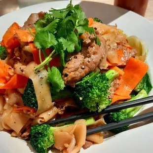 Wide rice noodles with beef and veggies.