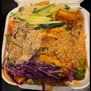 a variety of food in a styrofoam container