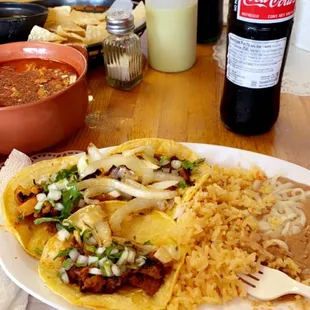 a plate of tacos and a bottle of coke