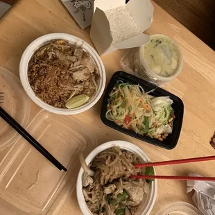 two bowls of noodles, chicken, and vegetables