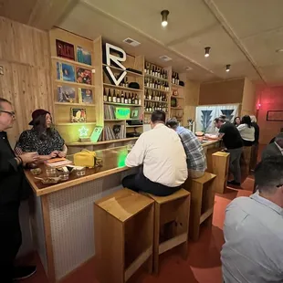 a group of people sitting at a bar