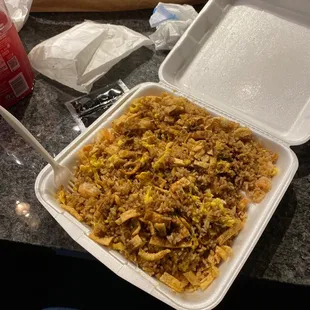 a container of rice with meat and vegetables