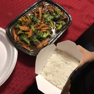 a person holding a box of rice