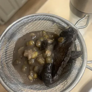 The burnt food that was filtered out of tea