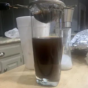 Tea filtered into glass with food and tea separated